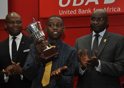 l-r: Mr. Kennedy Uzoka, Deputy Managing Director, UBA Plc,; Master Ezenwa Joseph Okonkwo, 1ST Prize Winner, student of Ambol Comprehensive High School, Akesan-Igando, Lagos (Middle); and Alhaji Alkali Mohammed,  President, Institute of Chartered Accountant of Nigeria (ICAN) at the grand finale ceremony of UBA Foundation National Essay Competition for Secondary School Students held at UBA House, in Lagos on Monday